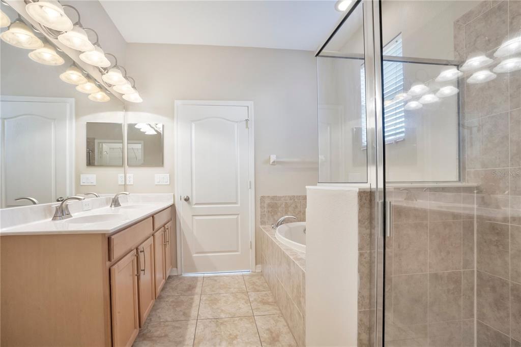 15031 Skip Jack Loop Lakewood Ranch, FL 34202 - Photo 14 of 27 a bathroom with a sink a toilet and shower