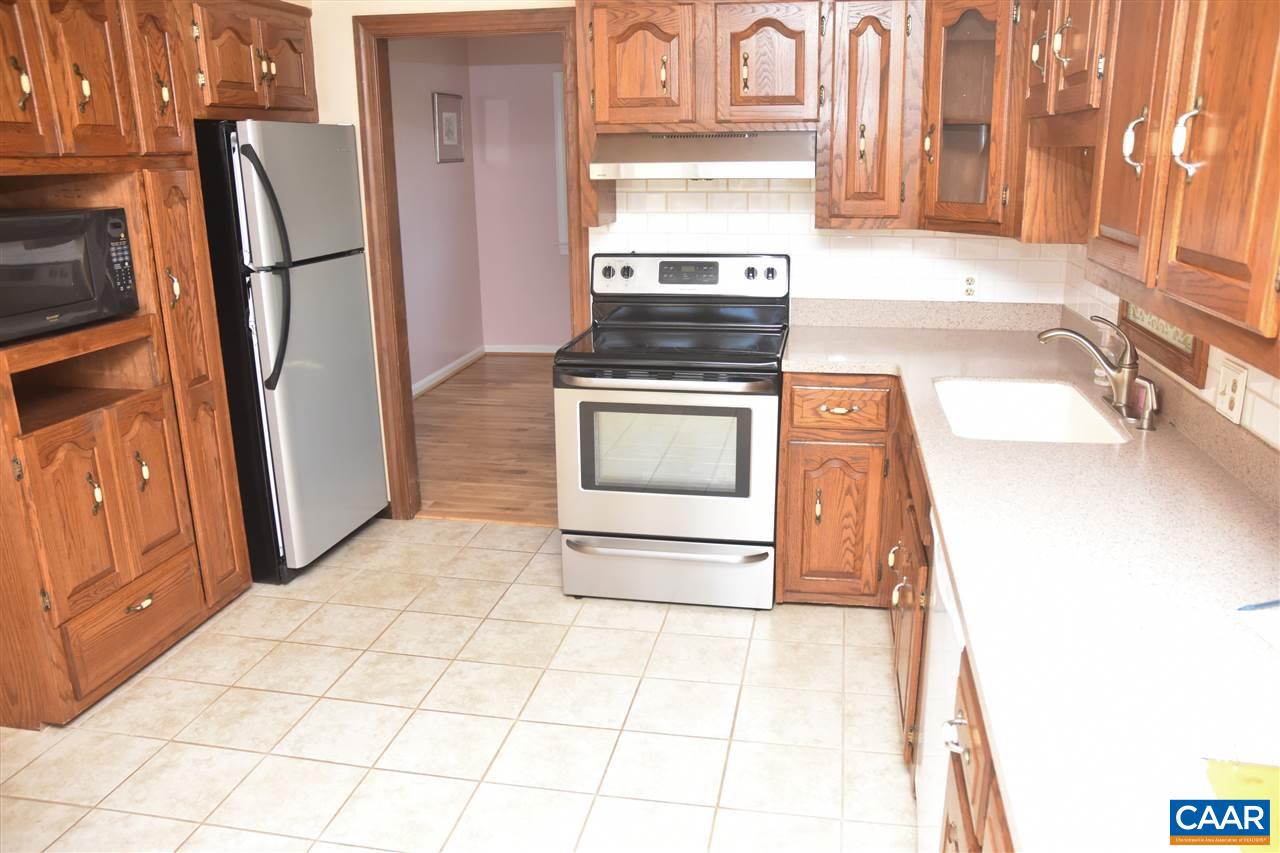 4193 Celt Road Stanardsville, VA 22973 - Photo 13 of 35 a kitchen with stainless steel appliances a stove a refrigerator and cabinets