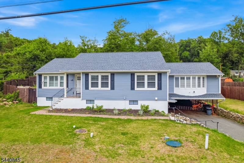 36 Forest Road Andover, NJ 07821 - Photo 16 of 50 a front view of a house with a yard table and chairs