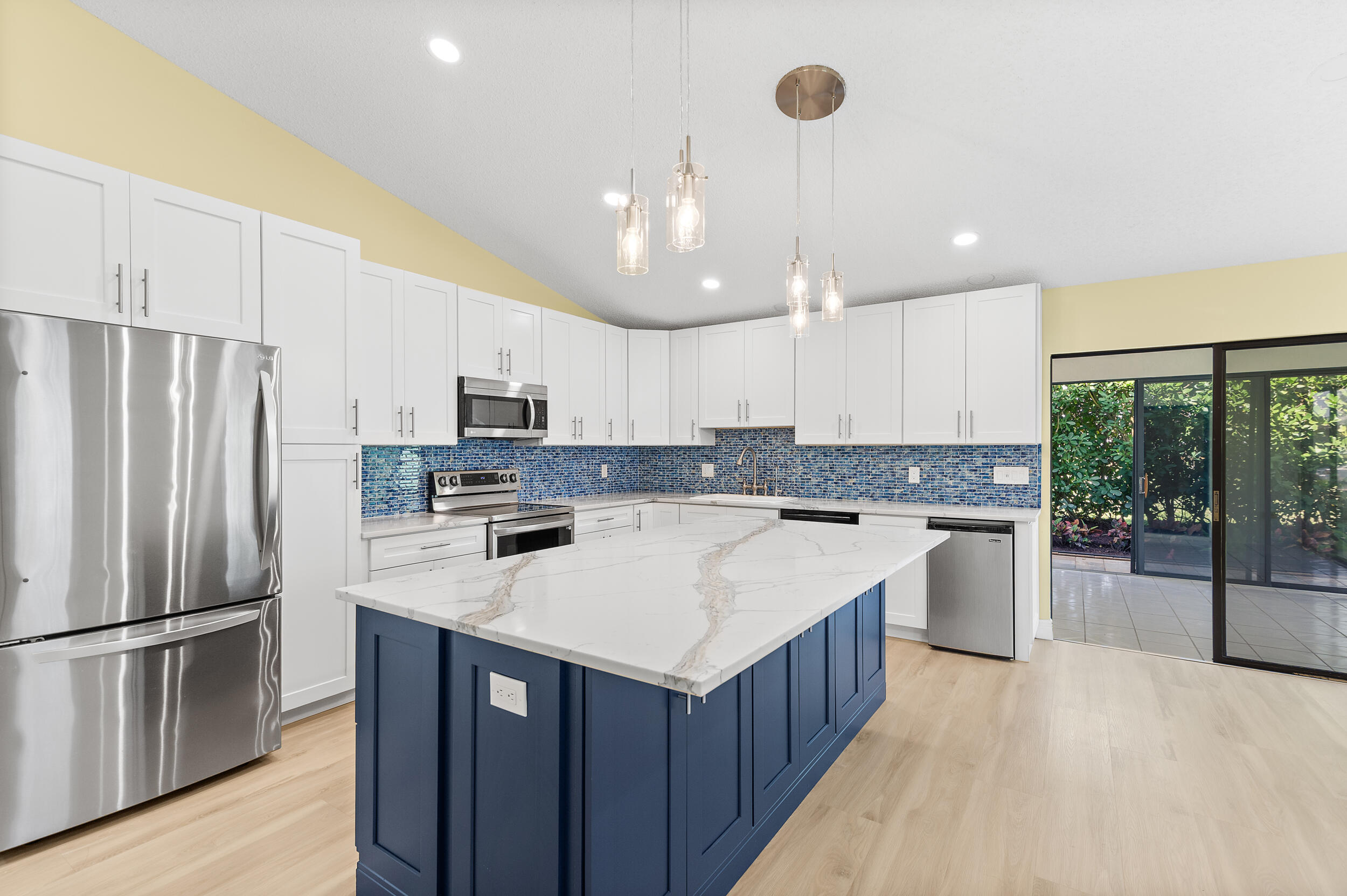 a kitchen with a refrigerator a sink and cabinets