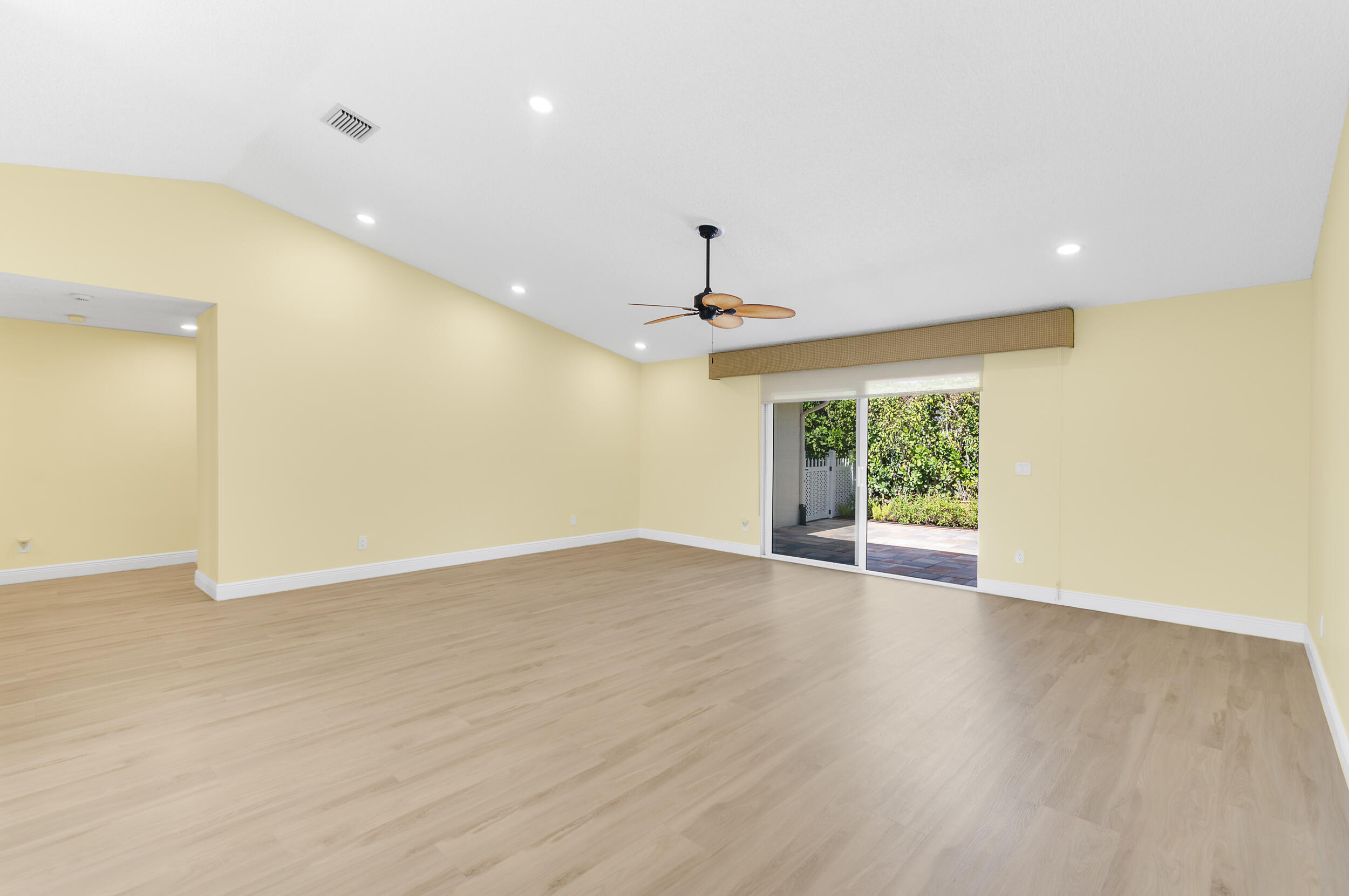 2685 Riviera Drive Delray Beach, FL 33445 - Photo 12 of 48 a view of an empty room with wooden floor and a window