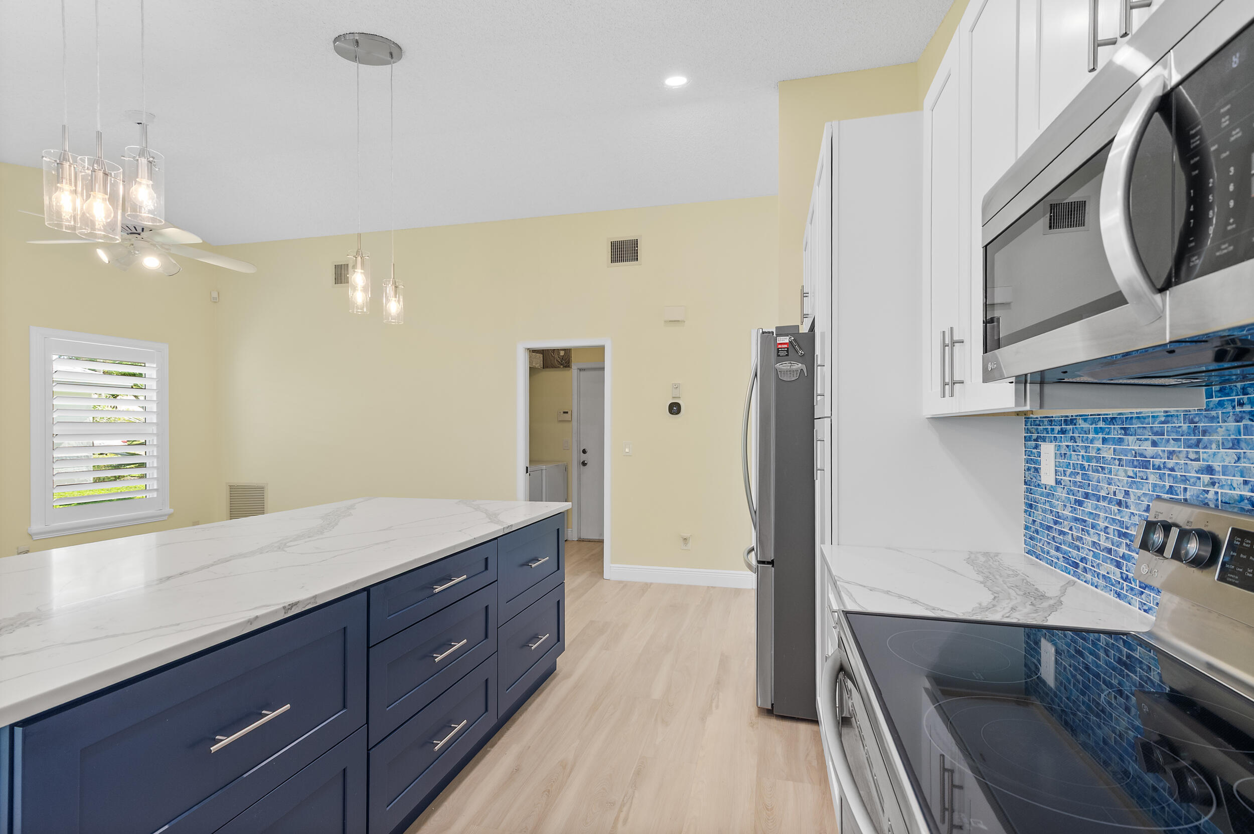 2685 Riviera Drive Delray Beach, FL 33445 - Photo 15 of 48 a spacious bathroom with a granite countertop double vanity sink a mirror and a shower