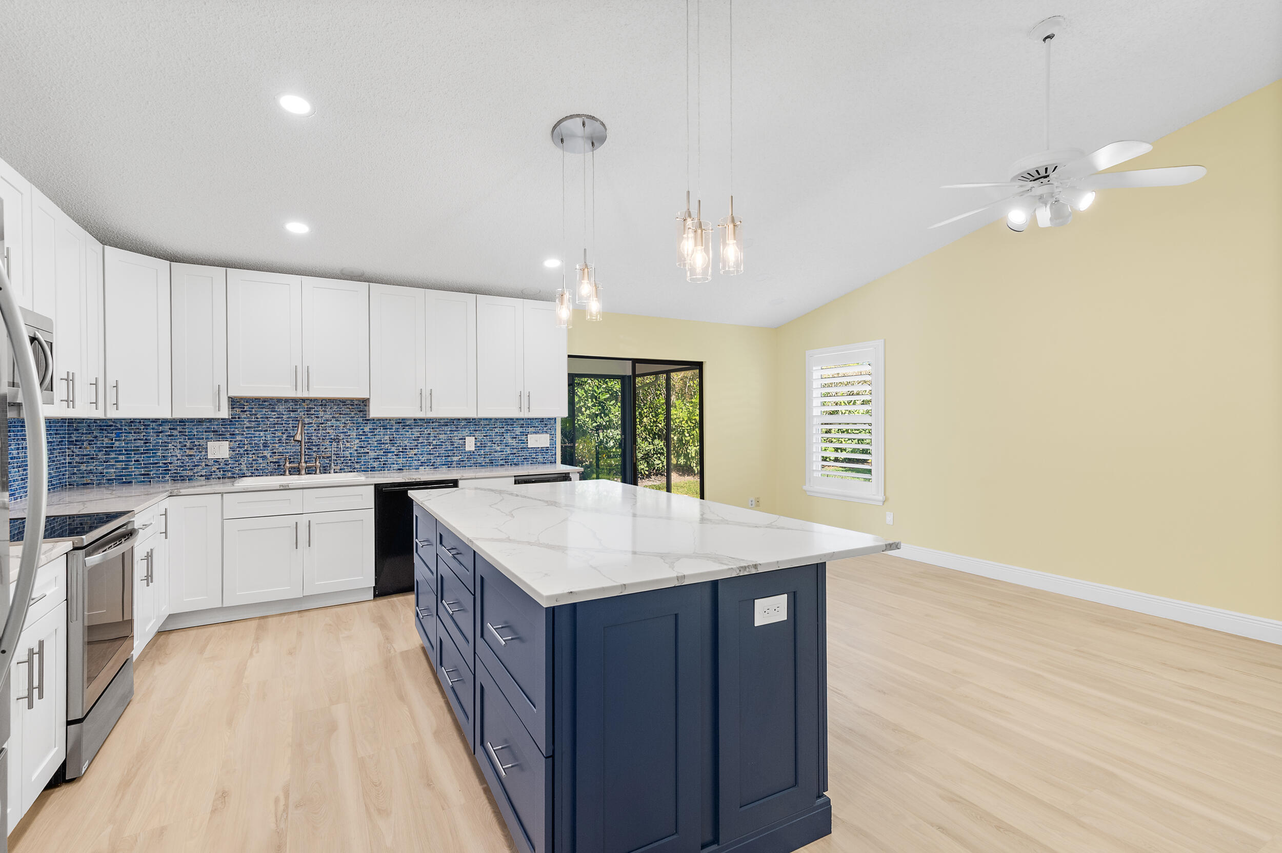 2685 Riviera Drive Delray Beach, FL 33445 - Photo 16 of 48 a kitchen with a sink stove and cabinets