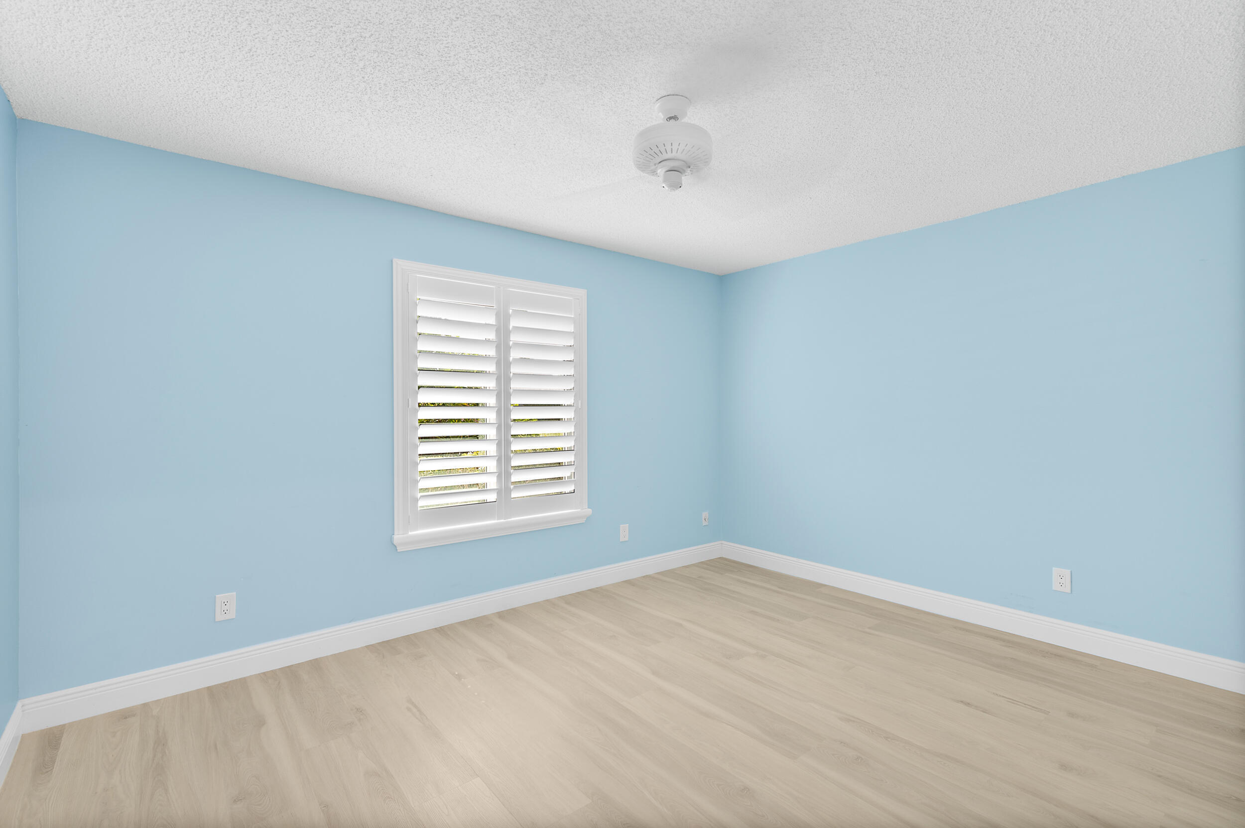 2685 Riviera Drive Delray Beach, FL 33445 - Photo 23 of 48 a view of an empty room with wooden floor and a window