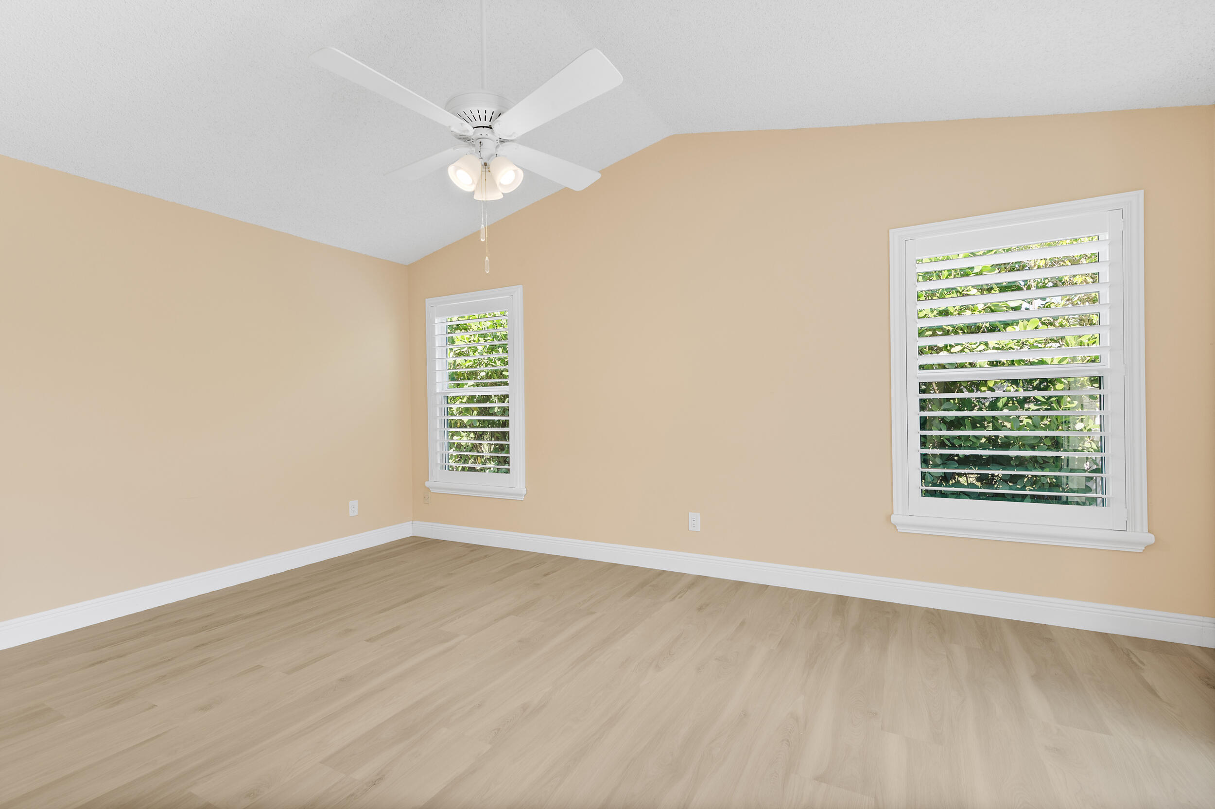 2685 Riviera Drive Delray Beach, FL 33445 - Photo 27 of 48 an empty room with wooden floor and windows