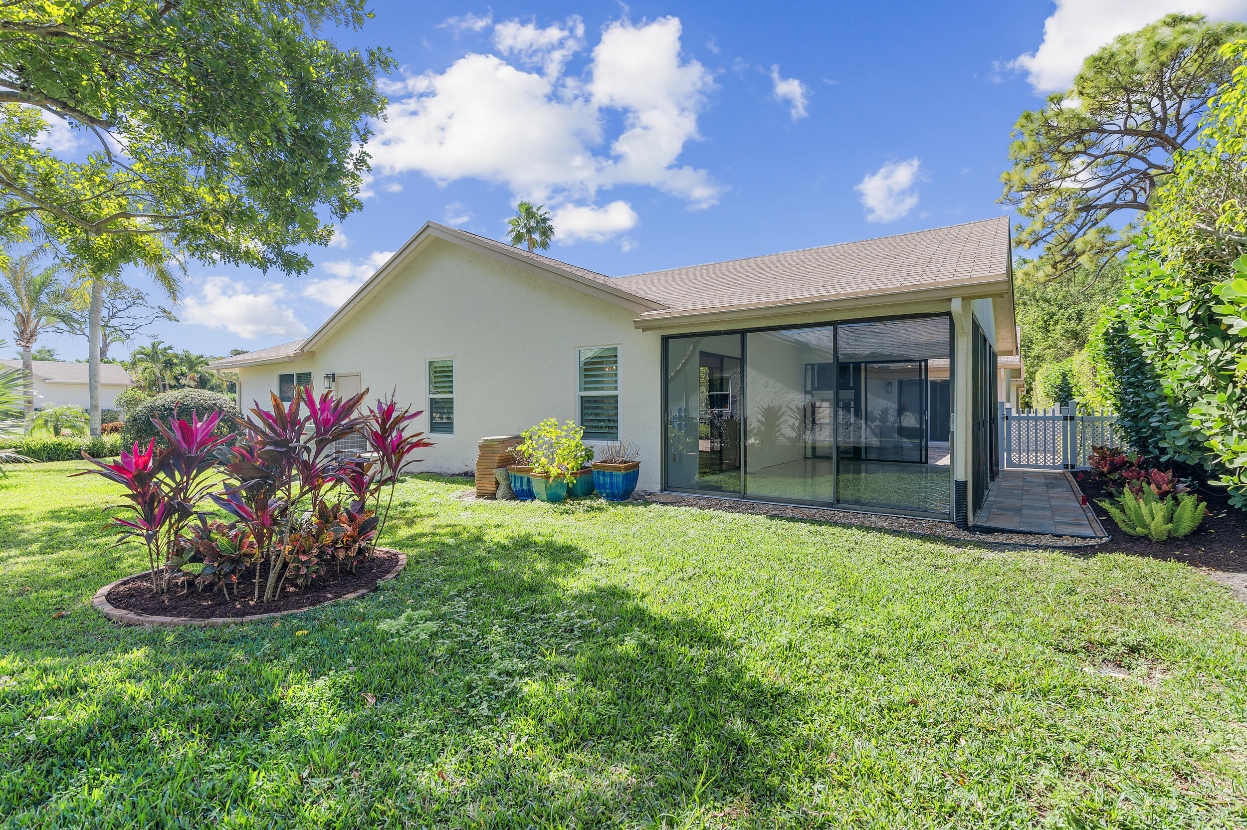 2685 Riviera Drive Delray Beach, FL 33445 - Photo 37 of 48 a front view of a house with a yard and a garden