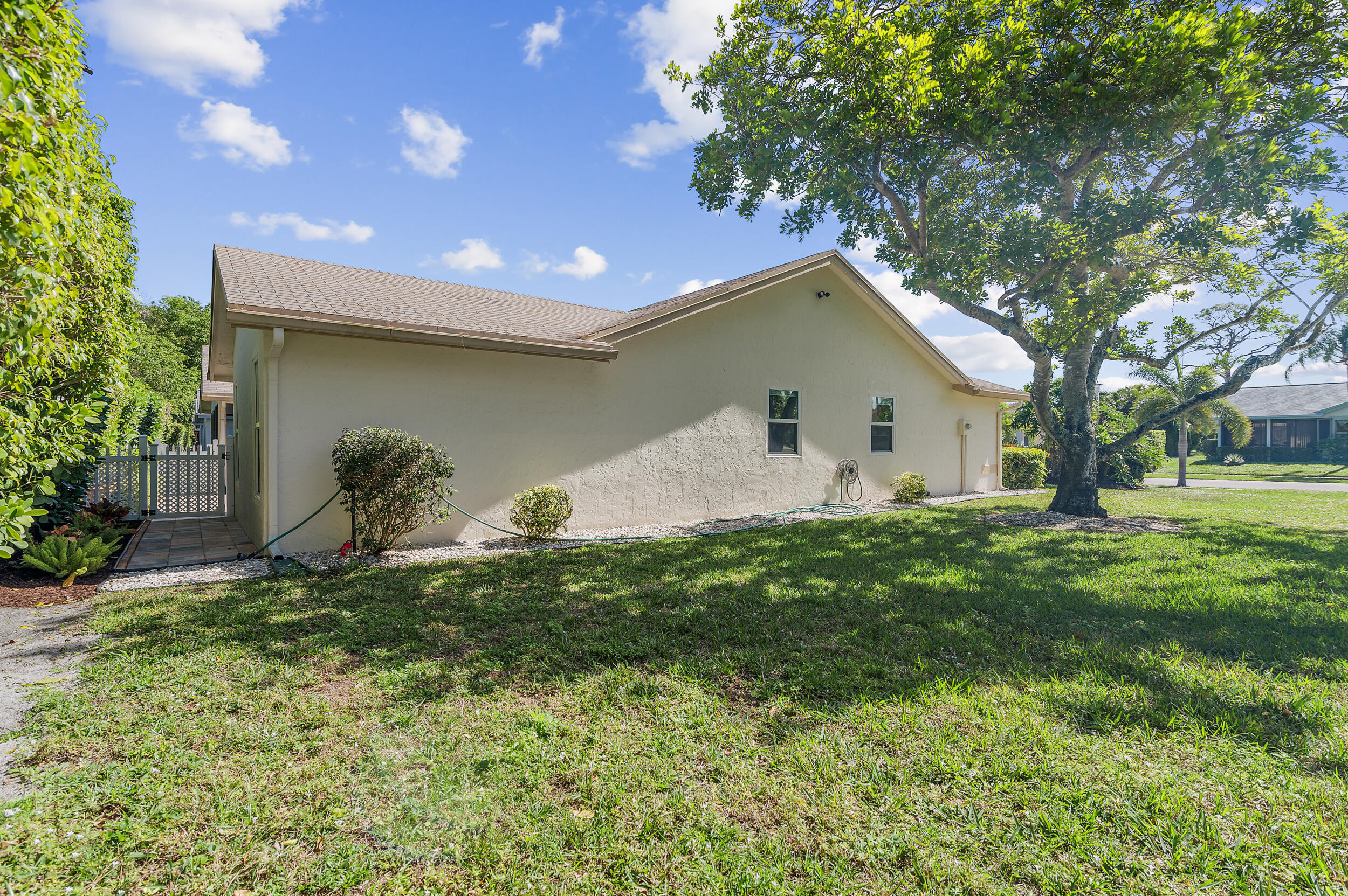 2685 Riviera Drive Delray Beach, FL 33445 - Photo 38 of 48 a backyard of a house with plants and tree