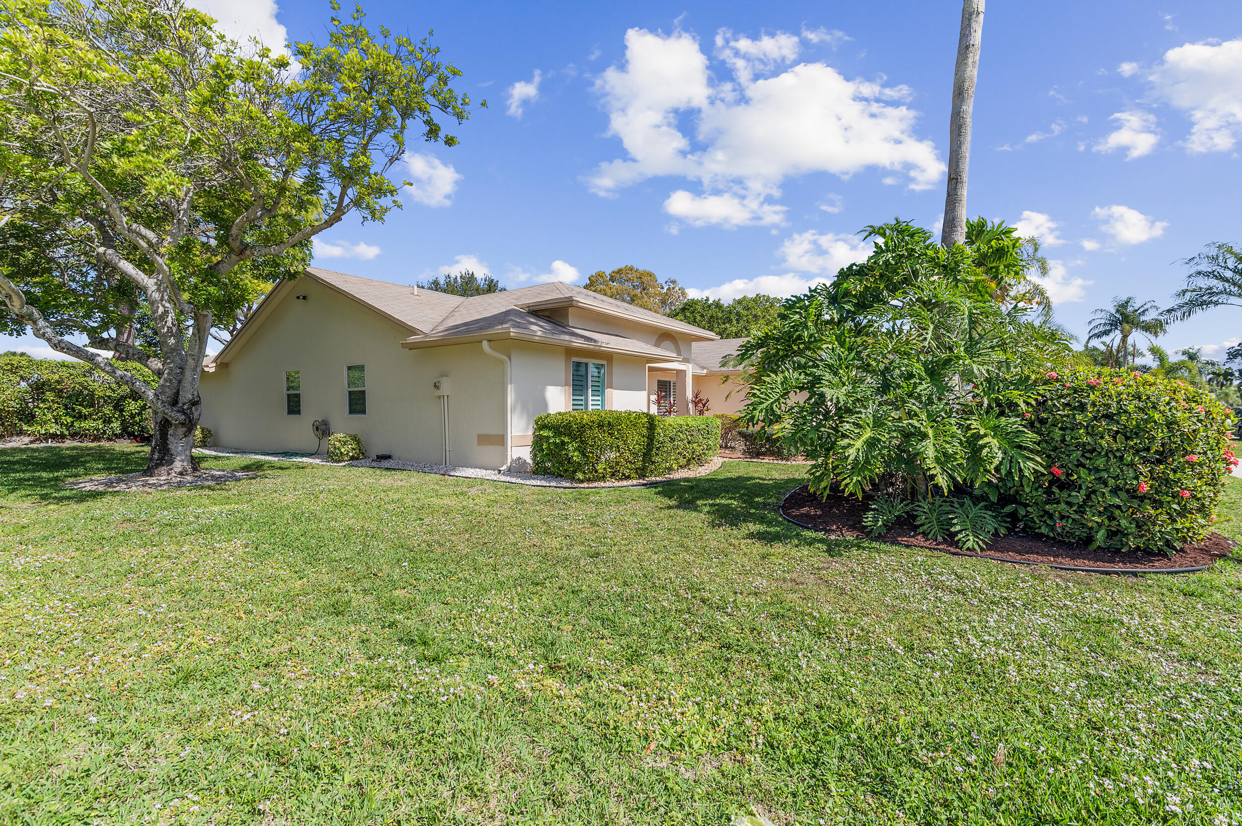 2685 Riviera Drive Delray Beach, FL 33445 - Photo 40 of 48 a view of a house with a big yard and potted plants