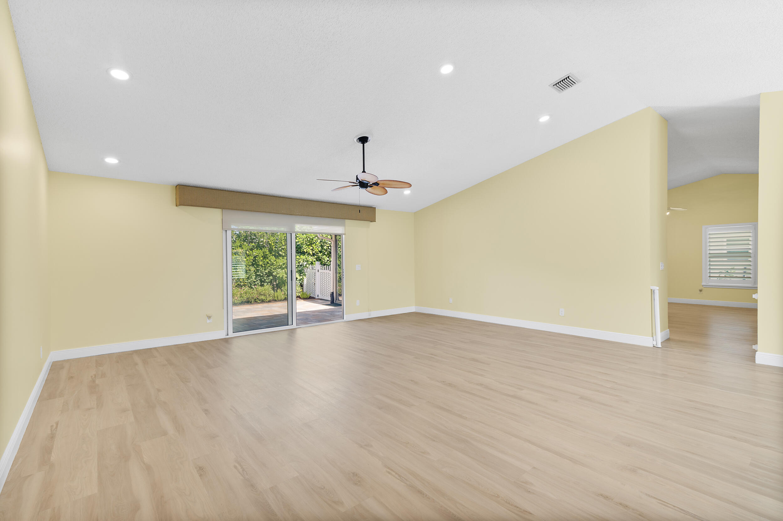2685 Riviera Drive Delray Beach, FL 33445 - Photo 8 of 48 a view of an empty room with wooden floor fridge and a window