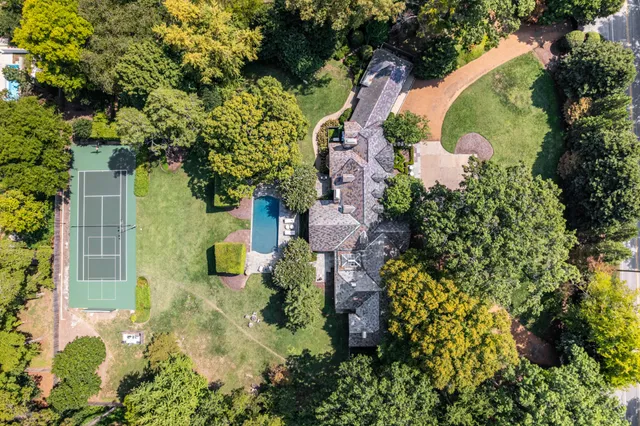 an aerial view of a house with a yard and garden