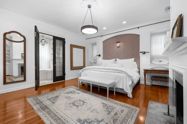 a bed room with a bed mirror and a window