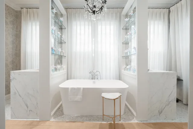 a dining room with chandelier and wooden floor
