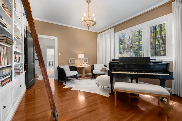 a living room with furniture fireplace and a large window