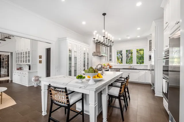 a view of a dining room with furniture and chandelier