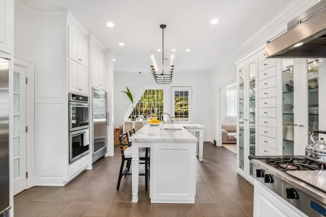 a kitchen with stainless steel appliances kitchen island granite countertop a stove and a refrigerator
