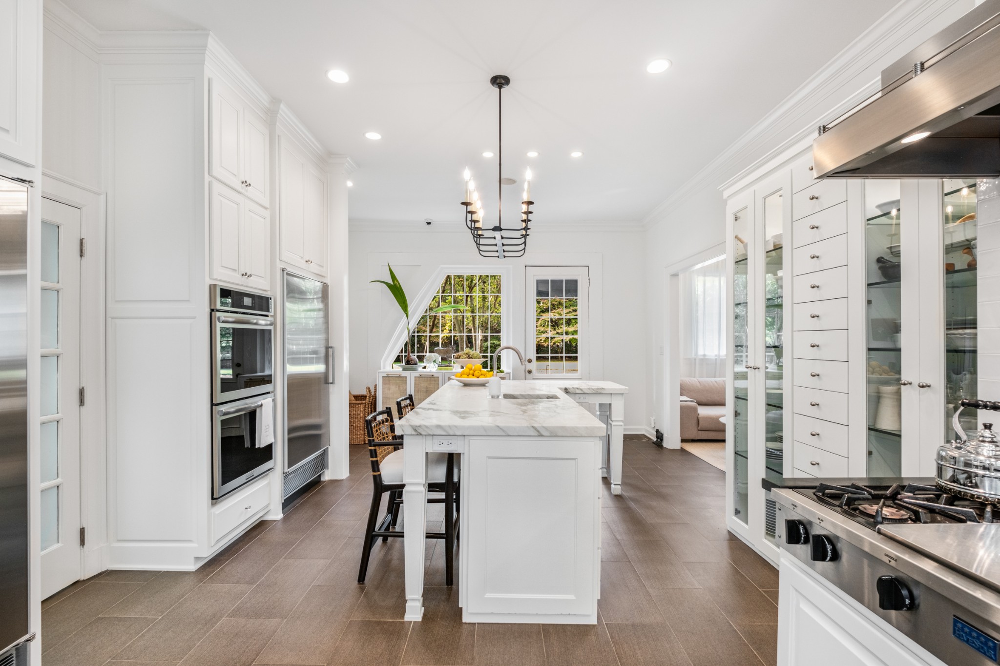 3800 Woodlawn Drive Nashville, TN 37215 - Photo 29 of 43 a kitchen with stainless steel appliances kitchen island granite countertop a stove and a refrigerator