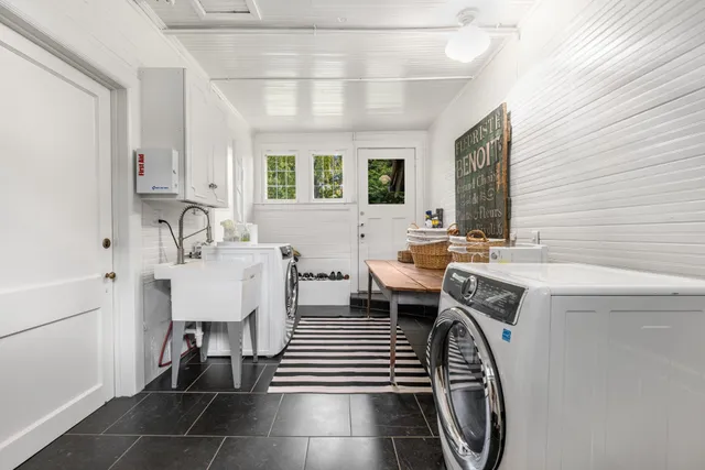 a kitchen view with wooden floor and cabinets