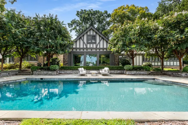a view of a house with swimming pool and sitting area
