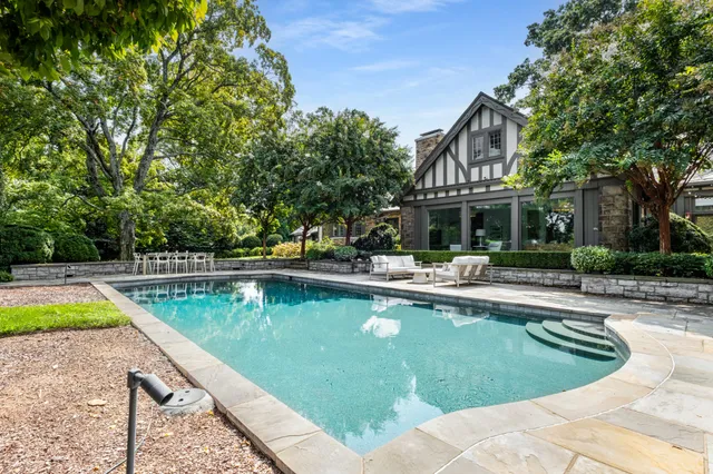 a view of a swimming pool with a lounge chair