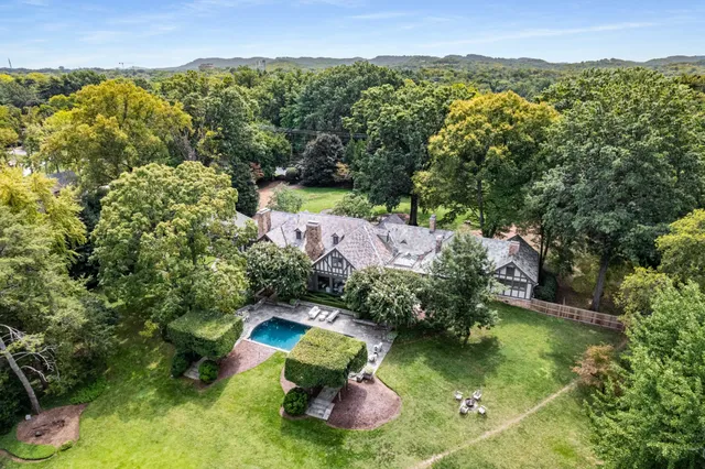 an aerial view of a house with a yard and garden