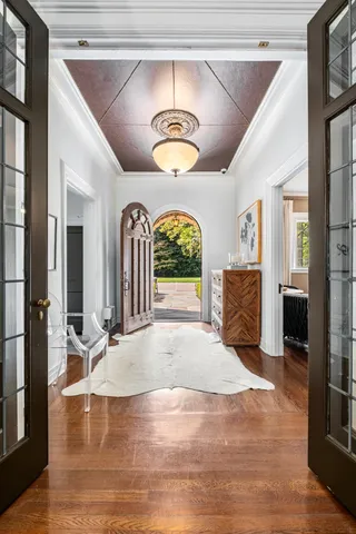 a view of a hallway with a stove a mirror and furniture