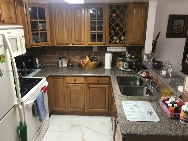 a white refrigerator freezer sitting inside of a kitchen