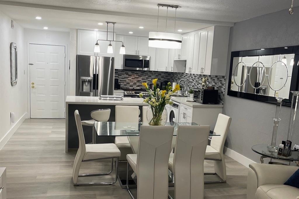 6950 Northwest 186th Street, Unit 2510 Hialeah, FL 33015 - Photo 1 of 19 a dining room with furniture and view of kitchen