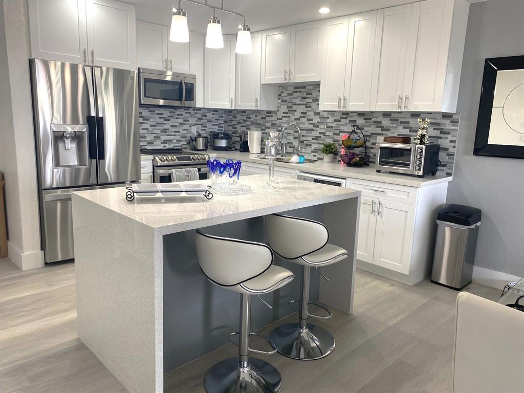 6950 Northwest 186th Street, Unit 2510 Hialeah, FL 33015 - Photo 3 of 19 a kitchen with stainless steel appliances granite countertop a sink and a stove