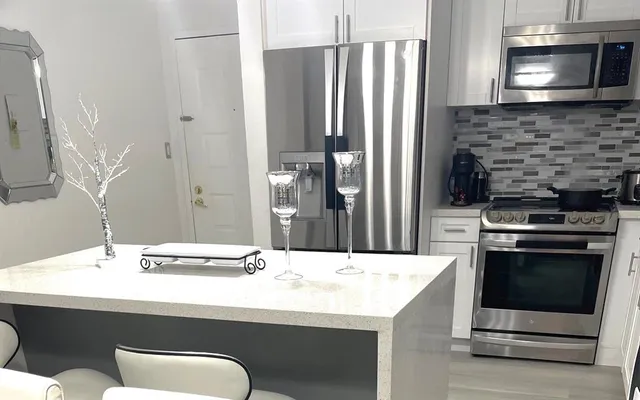 a bathroom with a sink and a stainless steel appliances