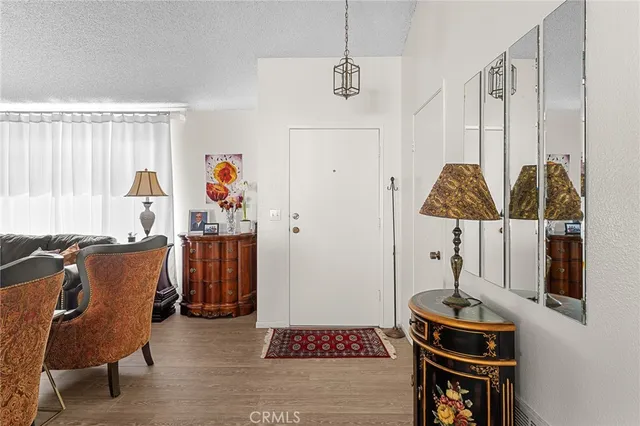 a living room with furniture a rug and a table