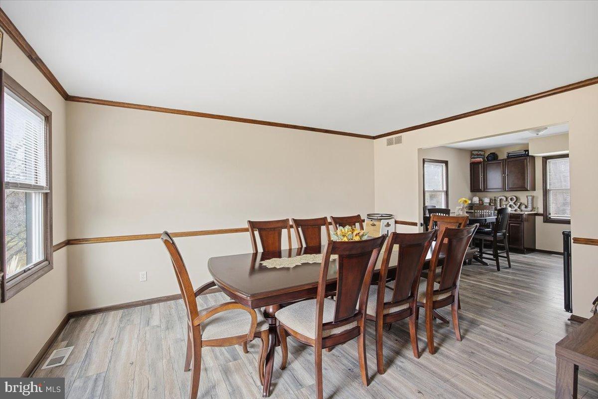 1518 Commissioners Road Mullica Hill, NJ 08062 - Photo 14 of 35 a view of a dining room with furniture and wooden floor