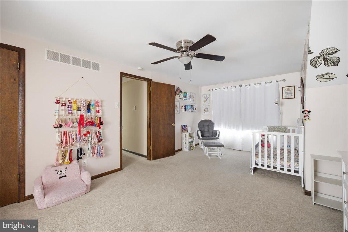 1518 Commissioners Road Mullica Hill, NJ 08062 - Photo 29 of 35 a view of a livingroom with furniture and a ceiling fan