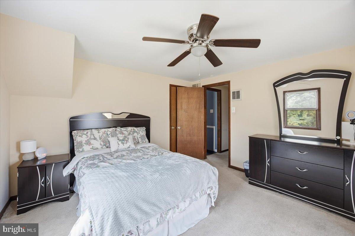1518 Commissioners Road Mullica Hill, NJ 08062 - Photo 33 of 35 a bedroom with a bed and a chandelier