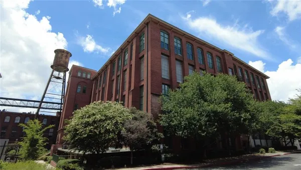 a view of a patio with chairs and table with chairs and umbrella