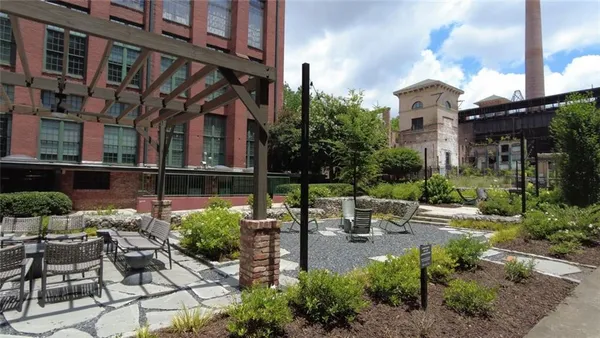 a view of a patio with table and chairs and potted plants