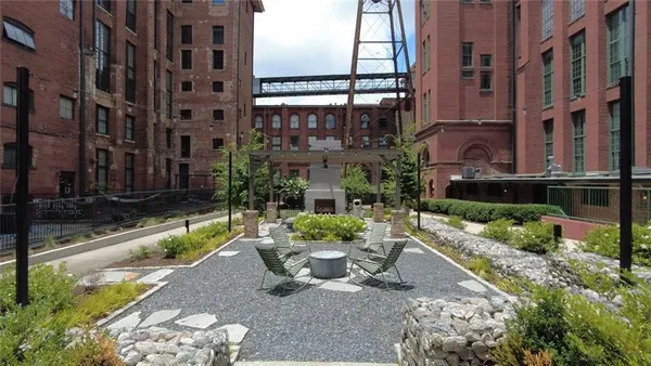 a view of a patio with couches table and chairs with potted plants