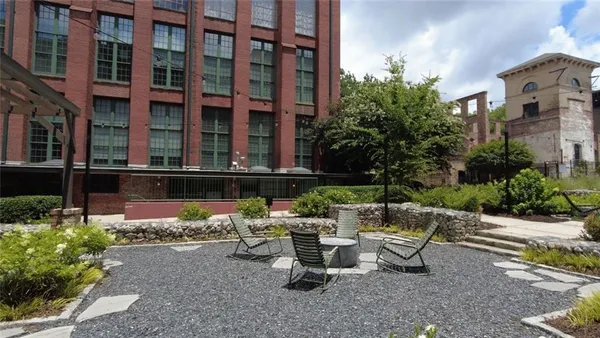 a view of a house with a yard and sitting area