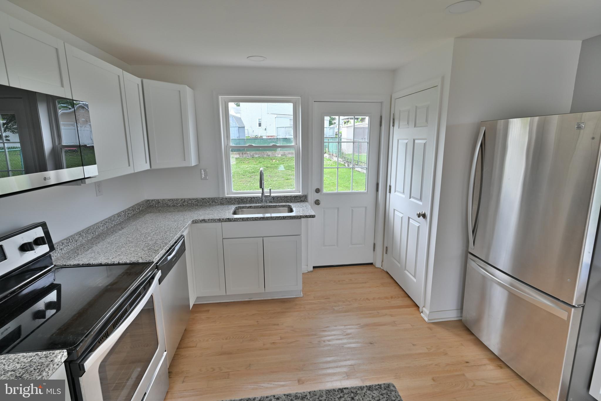 34 Compass Road East Middle River, MD 21220 - Photo 8 of 25 a kitchen with stainless steel appliances a refrigerator sink and stove