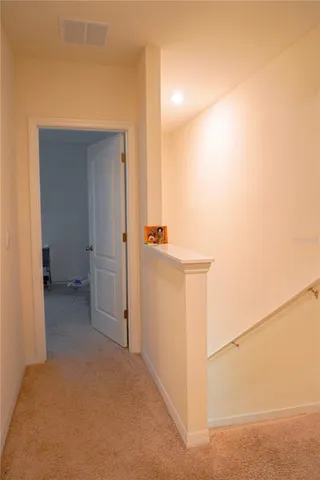 a bedroom with a bed and a lamp