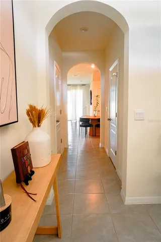 a kitchen with stainless steel appliances a sink a stove a refrigerator cabinets and a dining table