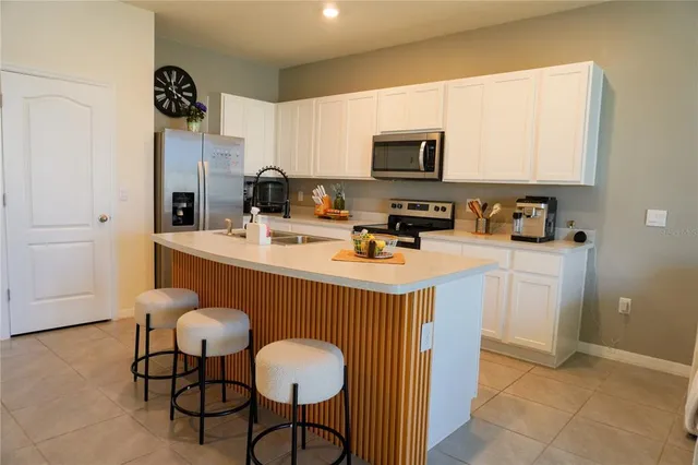 a living room with furniture and kitchen view