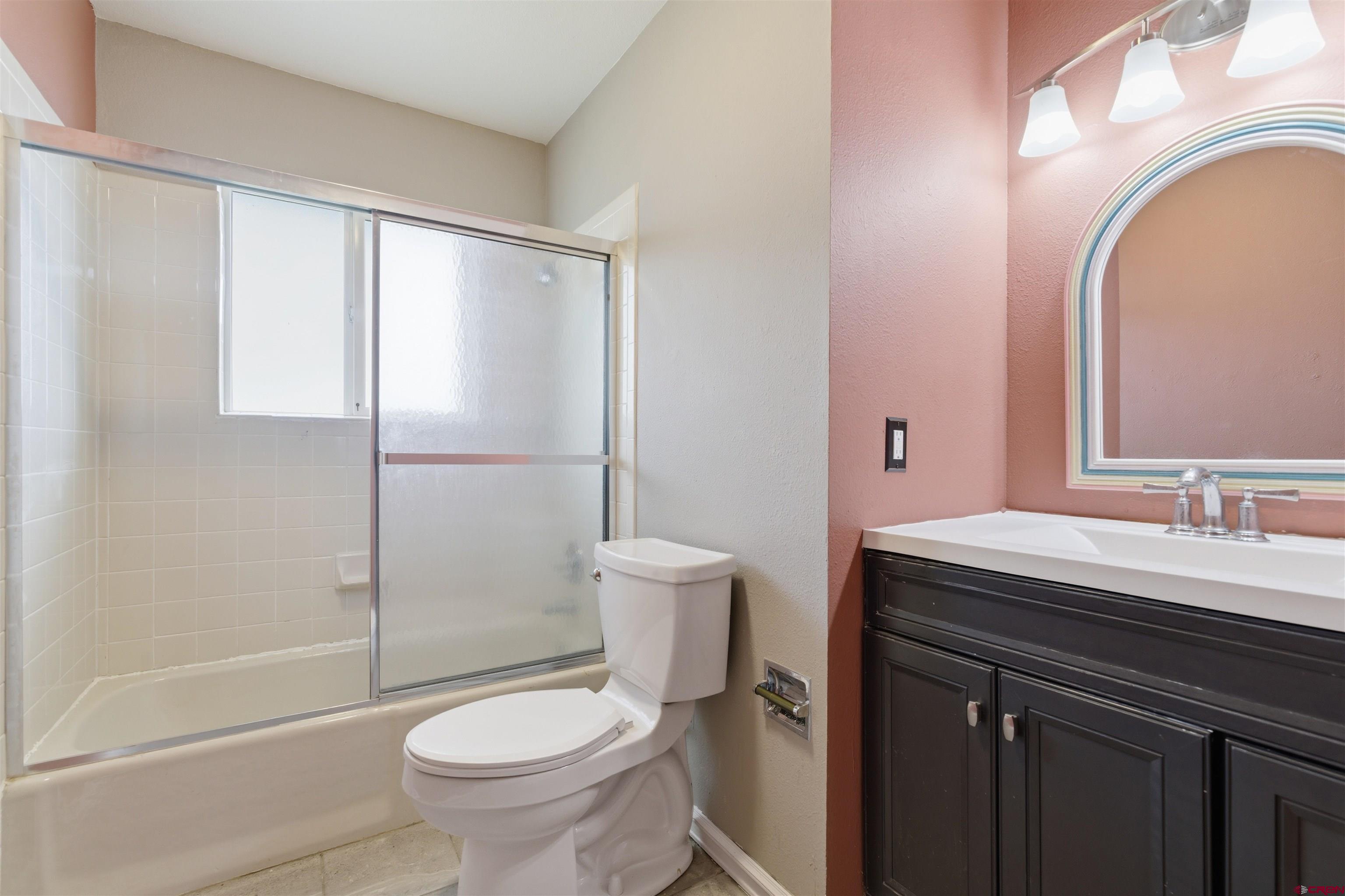 16216 2600th Road Cedaredge, CO 81413 - Photo 17 of 45 a bathroom with a granite countertop toilet a sink and a mirror