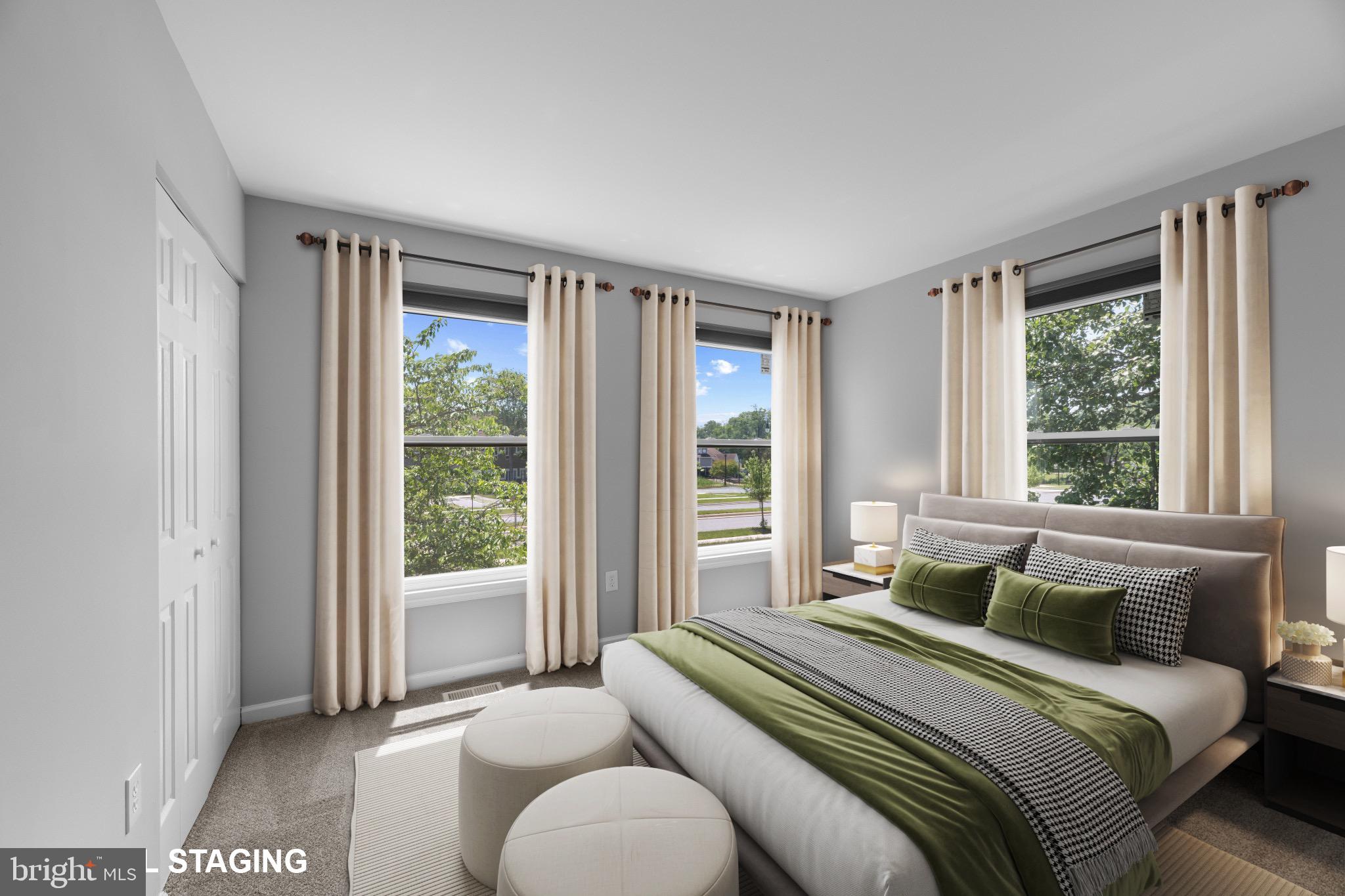 9302 Player Drive, Unit 155 Laurel, MD 20708 - Photo 32 of 43 a bedroom with a bed and a large window