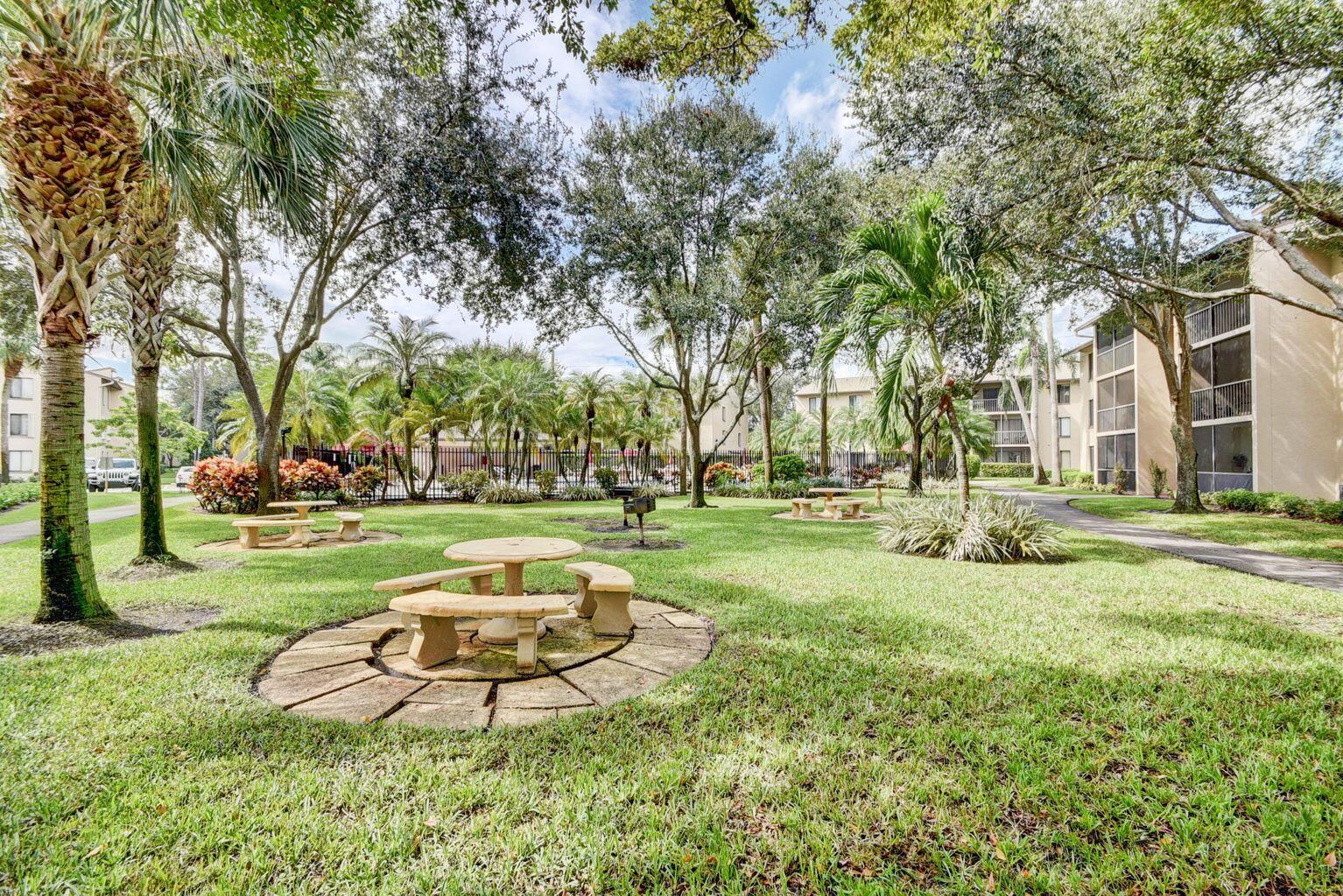 201 Foxtail Drive, Unit C2 Greenacres, FL 33415 - Photo 4 of 12 a view of a park with large trees