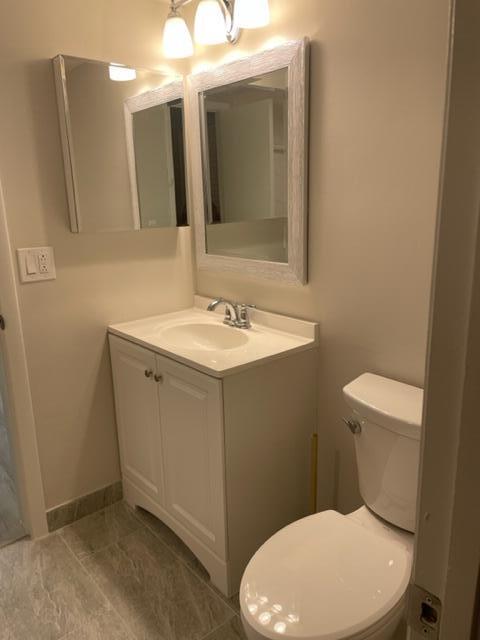 201 Foxtail Drive, Unit C2 Greenacres, FL 33415 - Photo 10 of 12 a white toilet sitting next to a bathroom sink