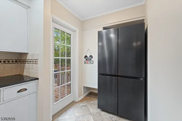 a view of kitchen with furniture and refrigerator