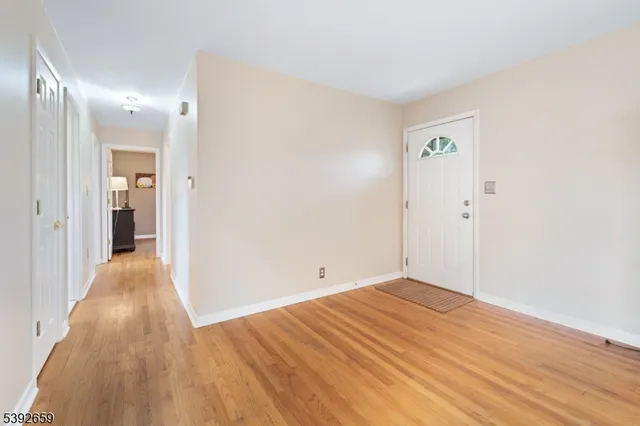 a view of a room with wooden floor and bathroom