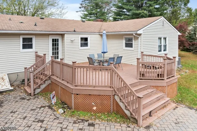 a view of a house with backyard sitting area and garden