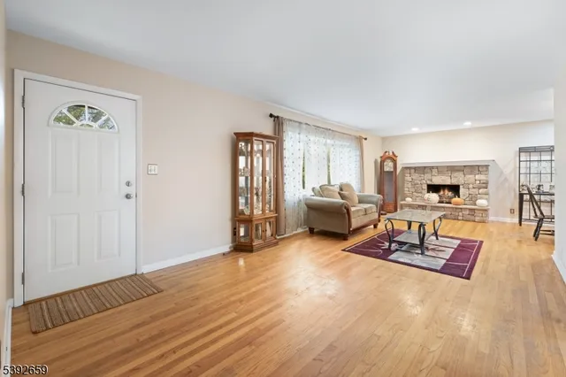 a living room with furniture and a table with wooden floor