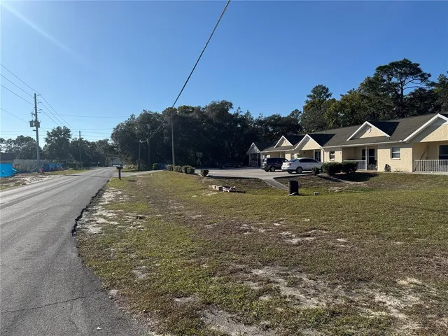 a view of a yard with a house in the background